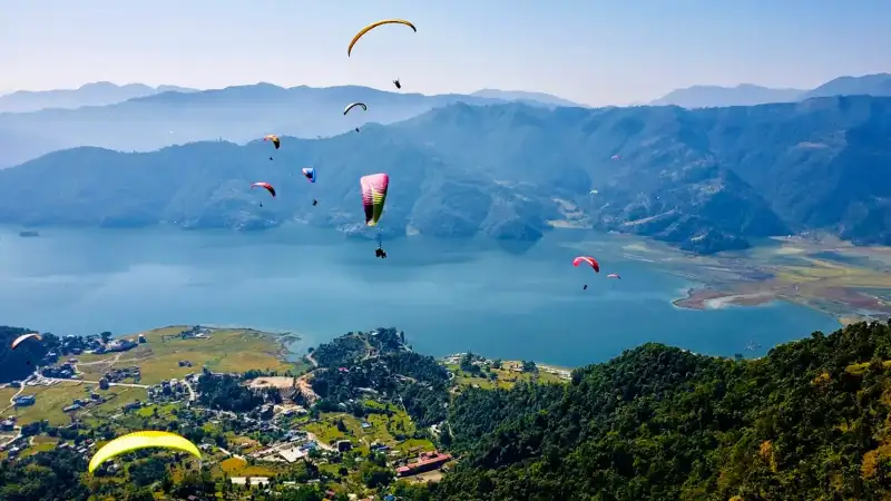 Paragliders flying over Phewa Lake, Pokhara